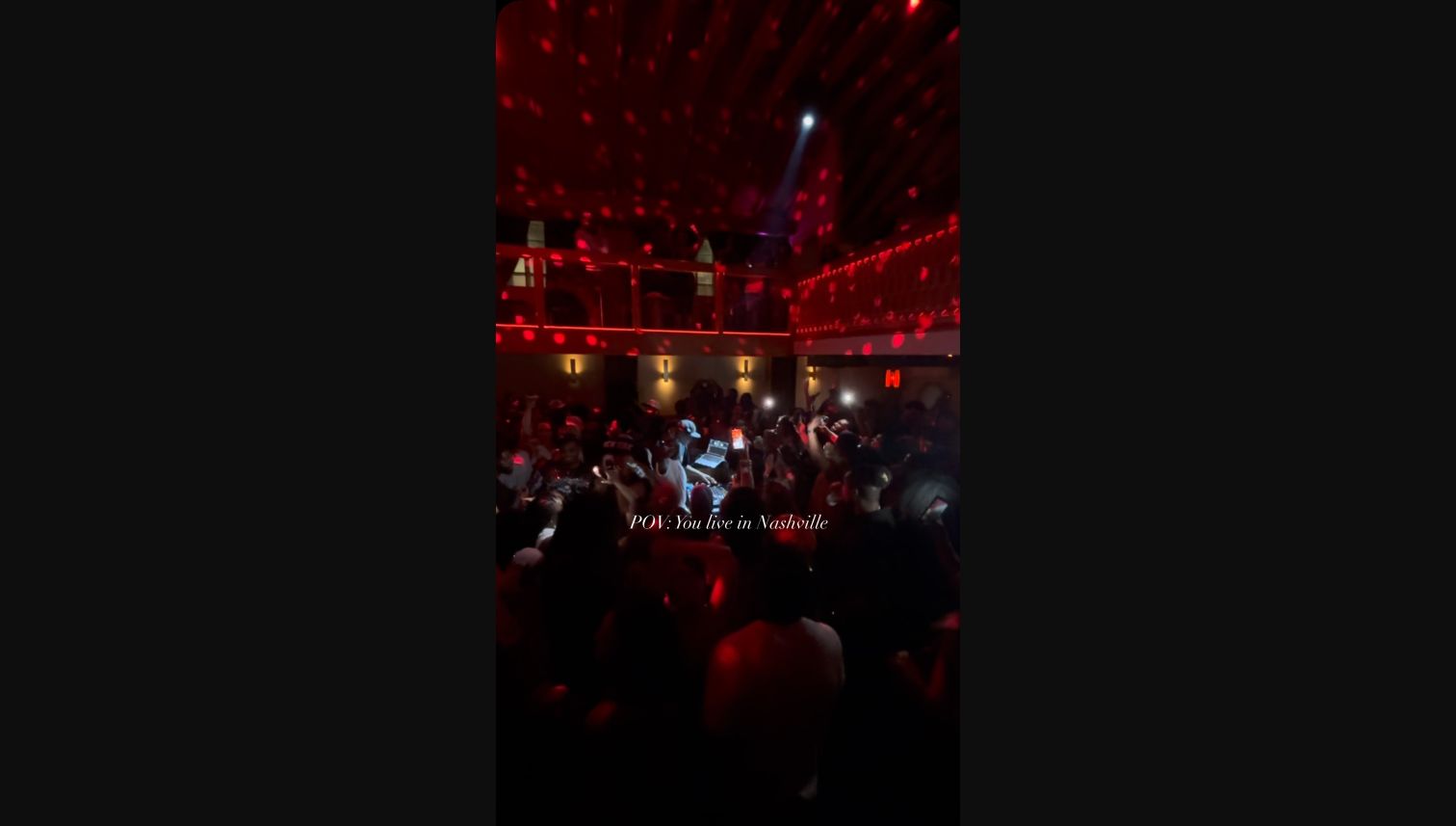 A red-lit crowd gathered around the music at The Last Friday